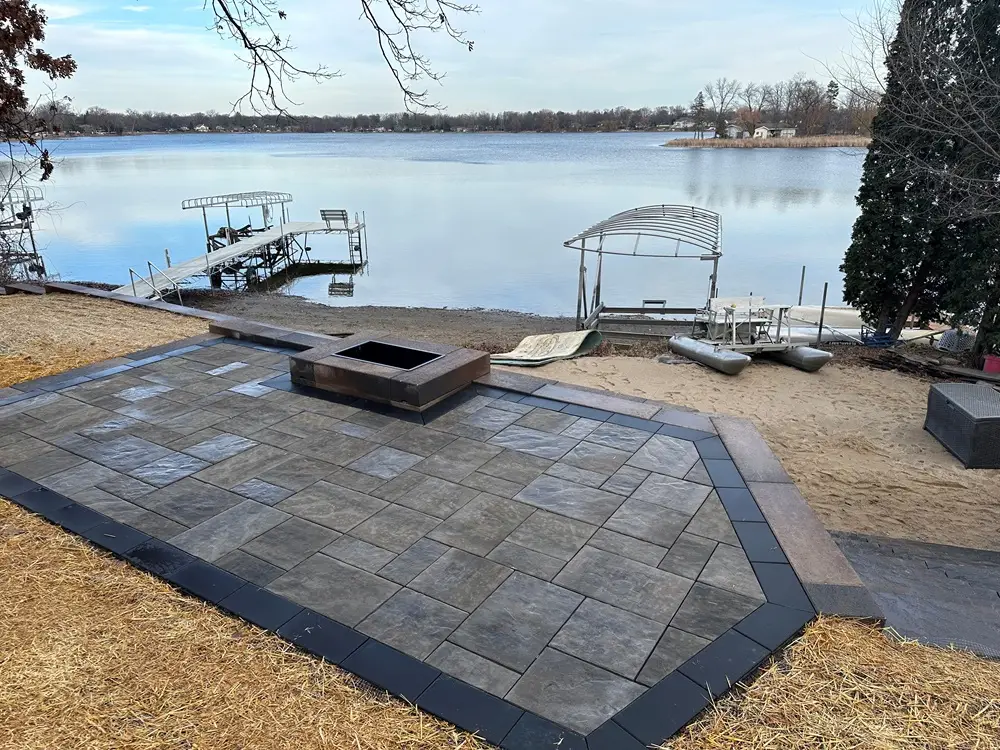 "Charming patio build on the lake in Muskego, WI, offering a serene retreat with stunning water views. Perfect for enjoying peaceful moments and outdoor gatherings in style. #MuskegoWI #LakePatio #OutdoorLiving #PatioDesign"