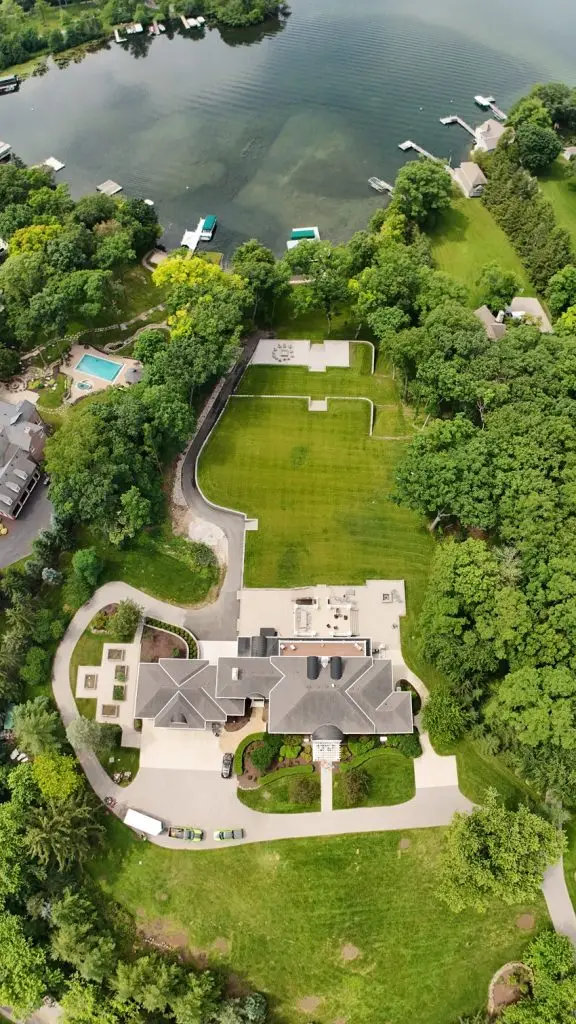 "Stunning Lake Country, Wisconsin landscape design featuring intricate retaining walls, elegant patios, and lush plantings. This meticulously crafted outdoor space blends natural beauty with sophisticated hardscaping for a truly remarkable setting. #LakeCountryWI #LandscapeDesign #RetainingWalls #Patios #GardenDesign"