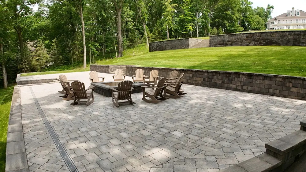 "Stunning patio in Lake Country, Wisconsin, featuring hillside retaining walls that enhance the natural beauty of the landscape. A perfect blend of elegance and function, creating a captivating outdoor retreat. #LakeCountryWI #PatioDesign #RetainingWalls #OutdoorLiving"