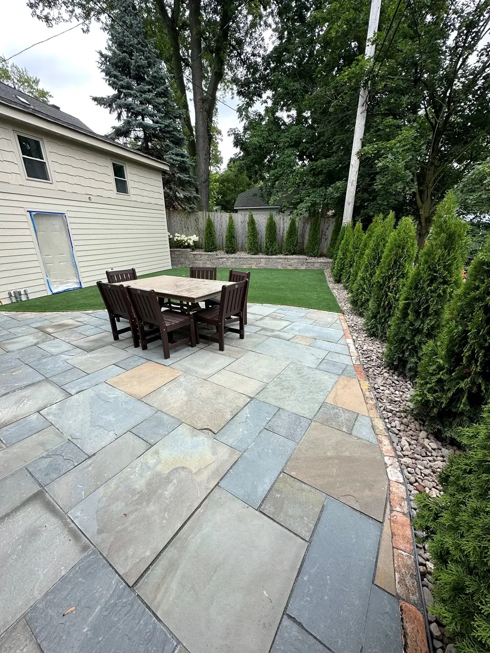 "Elegant paver patio and retaining wall in Whitefish Bay, WI, designed to enhance both style and function. This refined setup adds visual appeal and practical support, perfect for creating a sophisticated outdoor space. #WhitefishBayWI #PaverPatio #RetainingWall #OutdoorDesign"