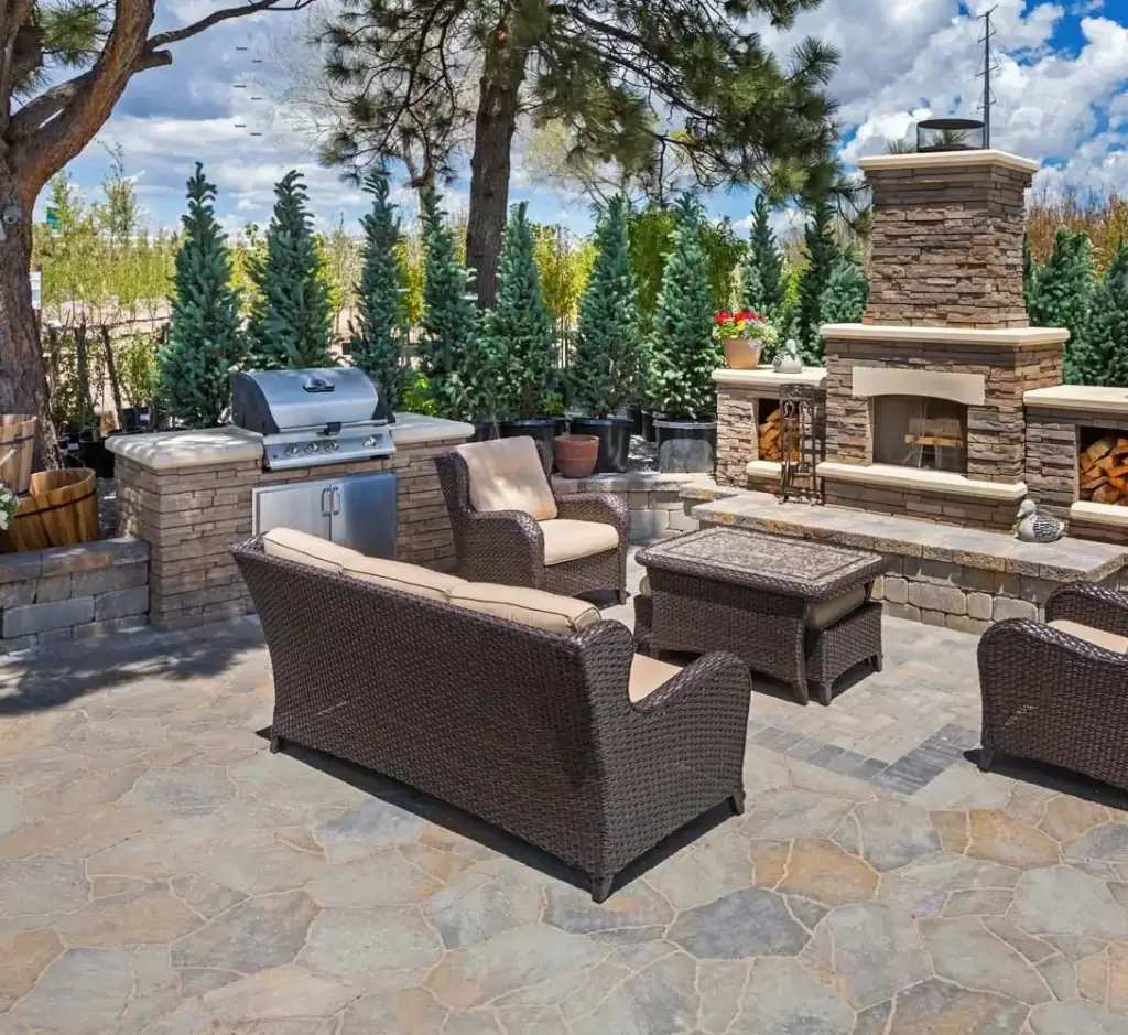 "Elegant outdoor kitchen with a grille, conveniently located near a cozy fireplace. This setup offers a seamless blend of cooking and relaxation, perfect for entertaining and enjoying outdoor meals. #OutdoorKitchen #Grille #Fireplace #OutdoorLiving"